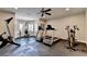 Spacious home gym featuring treadmills, rowing machine, weight machine and rubber flooring at 8340 Royal Melbourne Way, Duluth, GA 30097