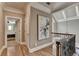 Hallway with hardwood floors, crown molding, and view of a bedroom through an open door at 8340 Royal Melbourne Way, Duluth, GA 30097