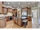 Gourmet kitchen with a large island, stainless steel appliances, and wood cabinets at 8340 Royal Melbourne Way, Duluth, GA 30097