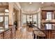 Gourmet kitchen leading to a sunlit breakfast nook with ample seating and large windows at 8340 Royal Melbourne Way, Duluth, GA 30097