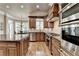 Spacious kitchen with stainless steel appliances, wood cabinets, granite countertops and hardwood floors at 8340 Royal Melbourne Way, Duluth, GA 30097
