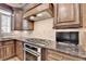 Gourmet kitchen featuring stainless steel appliances and granite countertops at 8340 Royal Melbourne Way, Duluth, GA 30097