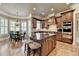 Bright kitchen with a breakfast nook, granite counters, stainless appliances, and custom wood cabinetry at 8340 Royal Melbourne Way, Duluth, GA 30097