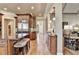 Gourmet kitchen showcasing a large island with seating, custom cabinetry, and stainless steel appliances at 8340 Royal Melbourne Way, Duluth, GA 30097