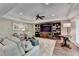 Spacious living room with hardwood floors, comfortable seating, and a built-in bookcase at 8340 Royal Melbourne Way, Duluth, GA 30097