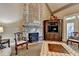 Living room features a stone fireplace, coffered ceilings, and hardwood floors at 8340 Royal Melbourne Way, Duluth, GA 30097