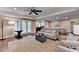 An open living area with hardwood floors, and a set of double doors leading outside at 8340 Royal Melbourne Way, Duluth, GA 30097