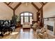 Cozy living room with high ceilings, grand piano, fireplace and floor to ceiling window at 8340 Royal Melbourne Way, Duluth, GA 30097