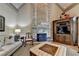 Elegant living room featuring a stone fireplace, coffered ceilings, and custom built-in shelving at 8340 Royal Melbourne Way, Duluth, GA 30097