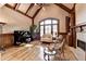 Beautiful living room with wood floors, beamed ceilings, a fireplace, and a wall of windows at 8340 Royal Melbourne Way, Duluth, GA 30097