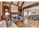 Open-concept living room adjacent to dining room with hardwood floors and fireplace at 8340 Royal Melbourne Way, Duluth, GA 30097
