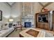 Vaulted living room features a stone fireplace, hardwood floors, and coffered ceilings at 8340 Royal Melbourne Way, Duluth, GA 30097