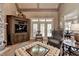Comfortable living room with a cozy design, a large window, and dark-stained wood elements at 8340 Royal Melbourne Way, Duluth, GA 30097