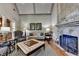 Living room featuring a stone fireplace and hearth with an adjacent seating area at 8340 Royal Melbourne Way, Duluth, GA 30097