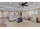 An open living area includes two couches, two chairs, and beautiful natural light at 8340 Royal Melbourne Way, Duluth, GA 30097