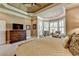 Main bedroom featuring plush bedding, crown molding, and natural light at 8340 Royal Melbourne Way, Duluth, GA 30097