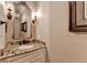 Bathroom with granite countertops, decorative mirror and lighting at 8340 Royal Melbourne Way, Duluth, GA 30097