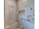 Walk in shower with seat, niche, and handrail in primary bathroom at 8340 Royal Melbourne Way, Duluth, GA 30097