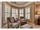 Cozy sitting area with natural light, comfortable chairs, and hardwood floors at 8340 Royal Melbourne Way, Duluth, GA 30097