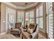 Sitting room with arm chairs and multiple windows with views at 8340 Royal Melbourne Way, Duluth, GA 30097