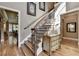 Staircase with hardwood flooring, iron railing, and trim at 8340 Royal Melbourne Way, Duluth, GA 30097