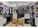 Walk-in closet with custom shelving, drawers, and clothes racks at 8340 Royal Melbourne Way, Duluth, GA 30097