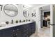 Bathroom with double vanity, modern mirrors, shelving and dark wood cabinetry, plus access to the kitchen at 199 14Th Ne St # 2312, Atlanta, GA 30309
