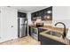 A well-lit kitchen with stainless steel appliances, dark cabinets, and granite countertops at 199 14Th Ne St # 2312, Atlanta, GA 30309