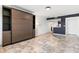 Sleek living space with a murphy bed, accented by tile flooring and modern finishes, open to the kitchen at 199 14Th Ne St # 2312, Atlanta, GA 30309