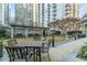 Inviting outdoor seating area surrounded by lush greenery and landscaping at 199 14Th Ne St # 2312, Atlanta, GA 30309
