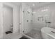 Bright bathroom featuring white tile, a glass-enclosed shower, and a standalone soaking tub at 2385 Nesbitt Dr, Brookhaven, GA 30319