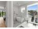 Modern bathroom with a luxurious tub, large windows, and a separate shower with glass door at 2385 Nesbitt Dr, Brookhaven, GA 30319