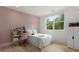 Bright bedroom featuring pink accent wall, white bed, wood floors, and natural light from the window at 2385 Nesbitt Dr, Brookhaven, GA 30319