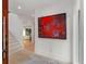 Bright entryway with a view to stairs, a view to the living room, and red modern art at 2385 Nesbitt Dr, Brookhaven, GA 30319