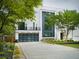 Modern home with a black framed garage door, second story balcony, and neatly landscaped front yard at 2385 Nesbitt Dr, Brookhaven, GA 30319