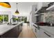 Gourmet kitchen with island, stainless steel appliances, and seamless flow to the dining and living areas at 2385 Nesbitt Dr, Brookhaven, GA 30319
