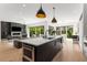 Spacious kitchen with an island and modern lighting overlooking the living room and outdoor patio at 2385 Nesbitt Dr, Brookhaven, GA 30319