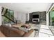 Contemporary living room featuring hardwood floors, fireplace, and lots of natural light at 2385 Nesbitt Dr, Brookhaven, GA 30319