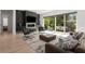 Open-concept living room with stylish decor, fireplace, and seamless indoor-outdoor flow to a covered patio at 2385 Nesbitt Dr, Brookhaven, GA 30319