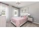 Charming bedroom with a soft pink theme, complemented by natural light and playful decor at 3062 Cambridge Mill St, Acworth, GA 30102