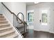 Inviting foyer featuring wood floors and staircase leading to the upper level at 3062 Cambridge Mill St, Acworth, GA 30102