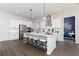 Bright kitchen with stainless steel appliances, white cabinets and a large center island at 3062 Cambridge Mill St, Acworth, GA 30102