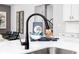Close up of modern kitchen sink with stainless steel appliances and white countertops at 3062 Cambridge Mill St, Acworth, GA 30102