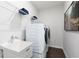 Functional laundry room with modern washer and dryer, shelving, and sink, ensuring convenience at 3062 Cambridge Mill St, Acworth, GA 30102
