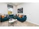 Cozy living room with a blue sectional sofa, patterned pillows, and natural light from a window at 3062 Cambridge Mill St, Acworth, GA 30102