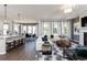 Open-concept space with a kitchen, dining, and living room with modern furnishings at 3062 Cambridge Mill St, Acworth, GA 30102