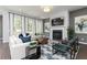Spacious living room featuring neutral tones, large windows, a fireplace, and stylish decor at 3062 Cambridge Mill St, Acworth, GA 30102