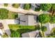 Birds eye view of home with gray shingled roof, green lawn, concrete drive, and mature trees at 3826 Baxley Village Trl, Suwanee, GA 30024