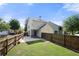 Spacious fenced backyard with a green lawn and patio, perfect for outdoor activities and entertaining at 3826 Baxley Village Trl, Suwanee, GA 30024