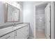 Bathroom showcasing a single vanity sink with white cabinetry and a shower tub at 3826 Baxley Village Trl, Suwanee, GA 30024